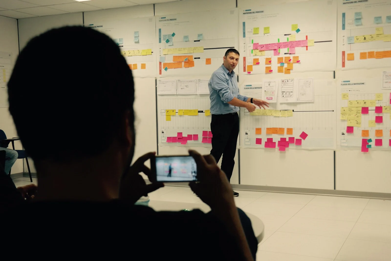 A participant presenting the team’s work at the board