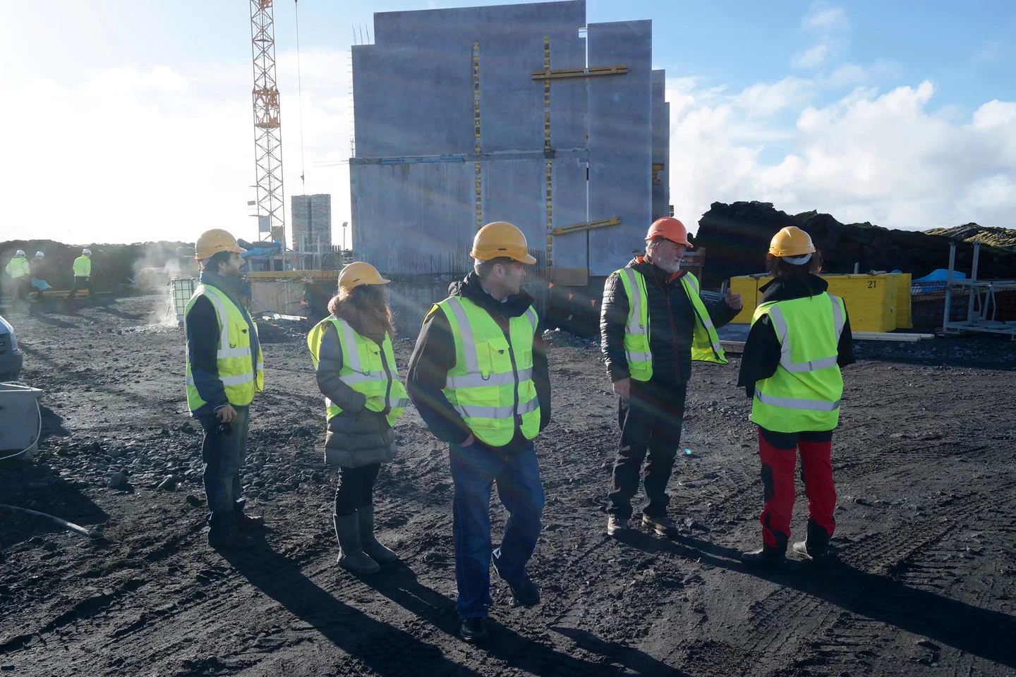 The project team visiting the construction site in hard hats and safety vests
