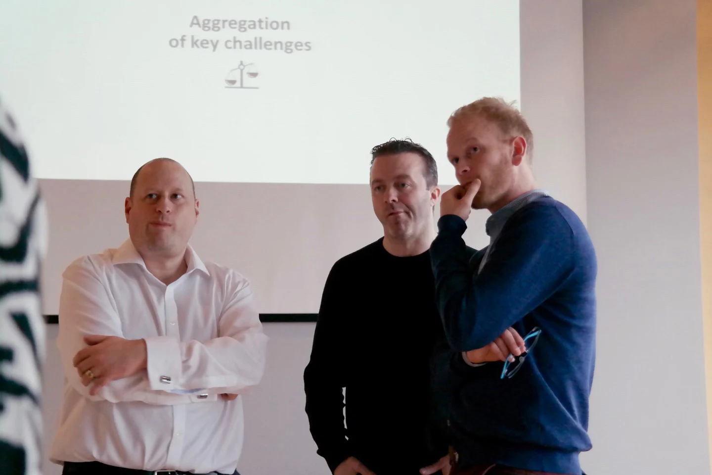 Three workshop participants reviewing challenges together