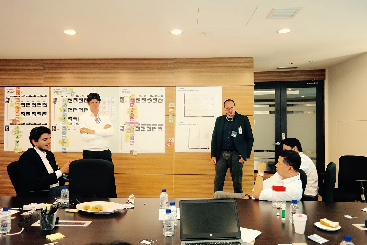 A facilitator standing beside the workshop board during a strategy discussion