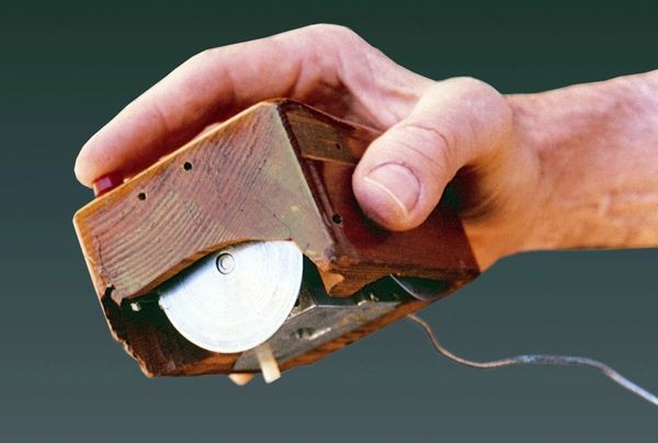 A close-up of the original mouse prototype and its tracking wheels
